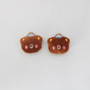 Detail of brown plush bear patches with party hats for JK uniform accessories