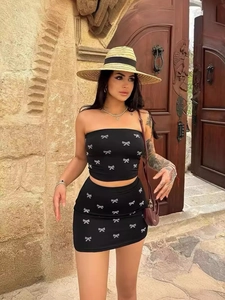 Sexy black two-piece set with tube top and mini skirt featuring shiny bow patterns