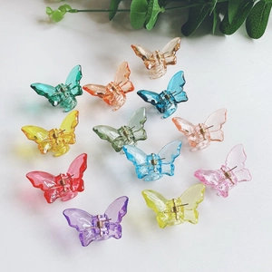 Top view of colorful acrylic butterfly hair claws with 12 pieces on a white background