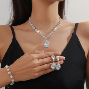 Close-up of luxury water-drop rhinestone necklace, earrings and bracelet set on model
