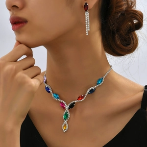 Detail of colorful marquise crystal necklace and earrings set on a female model