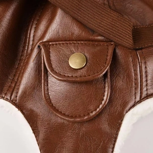 Detail of brown leather pilot hat showing metal snaps and white faux fur lining