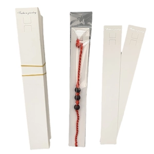 Red braided bracelet with black beads and Fashion Jewelry white display cards