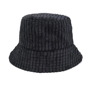 Detailed texture of black corduroy bucket hat with vertical stripe pattern and soft fabric