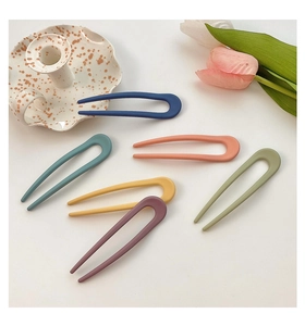 Detailed view of six colorful matte resin U-shaped hairpins in various candy colors