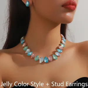 Close-up of model wearing colorful teardrop crystal necklace and earring jewelry set