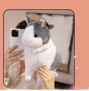 Detail of soft gray plush bunny wearing pink lace collar held by hand for size reference