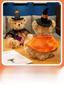Detail of Halloween teddy bears wearing witch hats and capes with pumpkin embroidery
