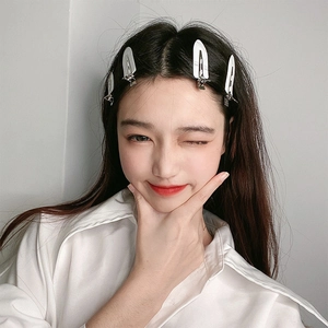 Model wearing three white leaf-shaped crease-free hair clips for hairstyling and makeup