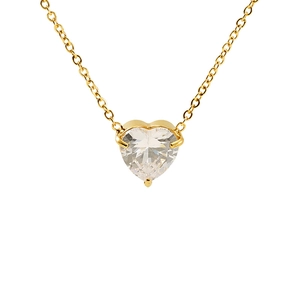 Close-up of heart-cut zircon pendant with three-prong setting on golden cross chain