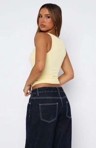 Detailed back view of yellow ribbed knit tank top showing fabric texture and slim fit design