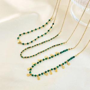Detail of 18K gold-plated stainless steel necklaces with natural green malachite beads