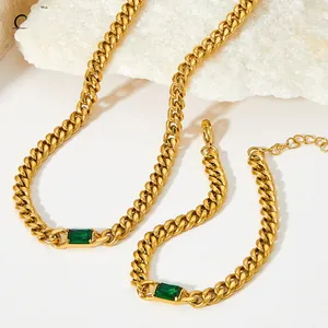 Detailed close-up of gold Cuban link chain set with rectangular emerald-cut green zircon