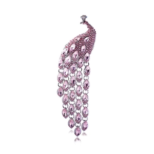 Detailed view of silver peacock brooch with pink rhinestones and dangling long tassels