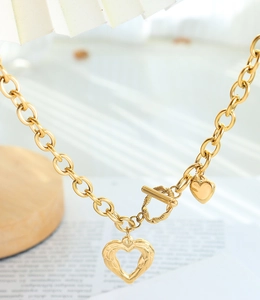 Detail of gold heart pendant necklace with OT toggle clasp and chunky chain links