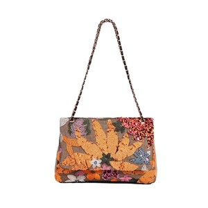 Straw shoulder bag with colorful floral sequins and metallic chain on white background