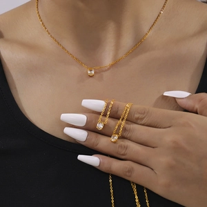 Minimalist gold plated necklace with oval zircon pendant on a thin chain worn by model