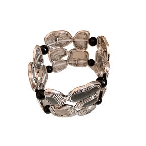 Vintage geometric silver cuff bracelet with black oval accents on a white background