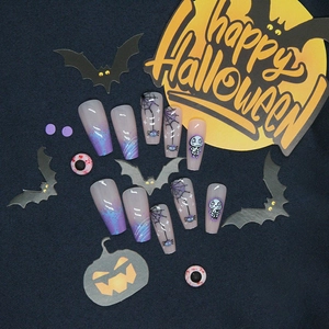 Detailed view of Halloween blue and purple gradient nails with spiders and skulls