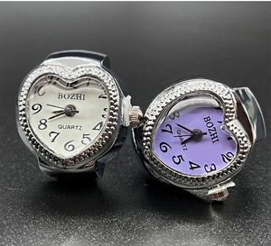 Detail of heart-shaped quartz ring watches with Arabic numerals and alloy finish