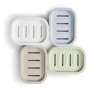 Top-down view of a 4-pack silicone soap dish set with drainage slots in Morandi colors