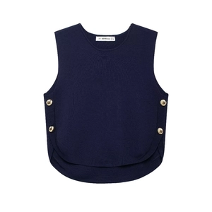 Detail of dark blue knit vest showing layered hem and gold buttons on a white background