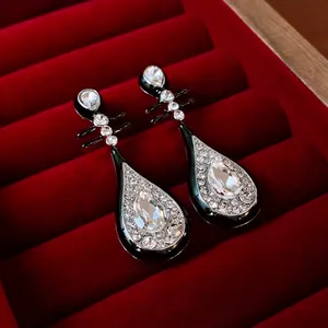 Elegant silver needle pipa drop earrings with black enamel and sparkling rhinestones
