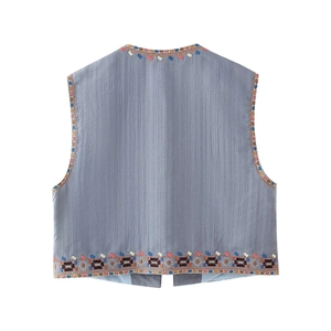 Detailed back view of grey-blue ethnic vest with colorful floral embroidery on linen fabric