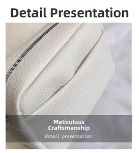Detailed close-up of white lychee pattern leather bag with premium silver zipper finish