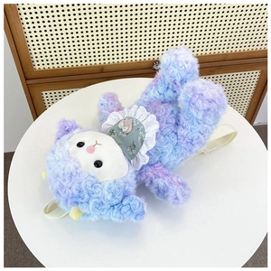 Top view of curly purple-blue plush lamb bag with floral bib on a white table surface