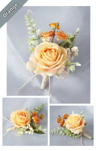 Close-up of orange artificial rose boutonniere with green leaves and gold twine bow