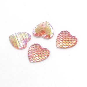 Close-up of 16mm heart-shaped resin cabochons with iridescent fish scale texture pattern