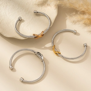 Minimalist stainless steel cable twist bangle with interlaced knot charm in three colors