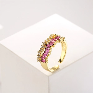 Close-up of gold double-row ring with rectangular red zircon and white stones