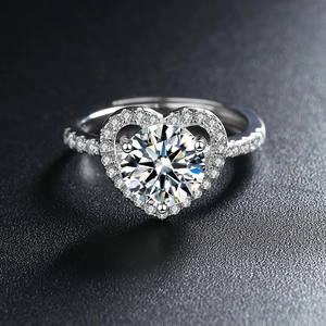 Sparkling heart-shaped zircon ring with halo setting on a textured black background