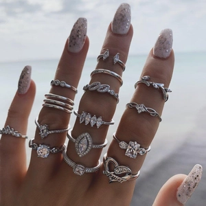 Silver-tone 14-piece ring set with crystals featuring heart and leaf designs worn on hand