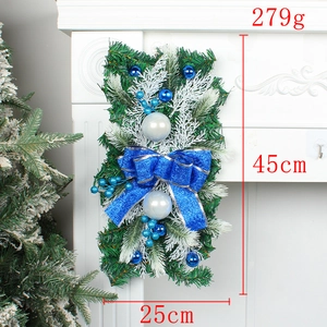 Detailed view of 45cm Christmas wreath with blue bows and ornaments on a fireplace
