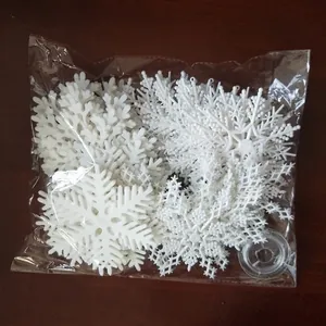 White plastic Christmas snowflake hanging decorations in a set for festive holiday styling