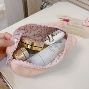Detail view of pink corduroy makeup bag with floral lining and spacious storage
