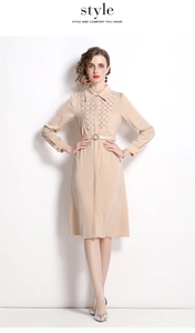 Detail of woven texture and metal buckle belt on long sleeve apricot shirt dress