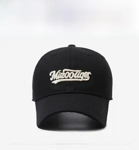 Close-up of high-quality white Kioooliger letter embroidery on black cotton baseball cap
