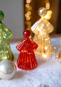 Macro detail of lighted mercury glass angels on a warm snowy background for Christmas