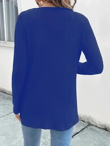 Detail of blue ribbed knit jacket showing premium texture and long sleeve design