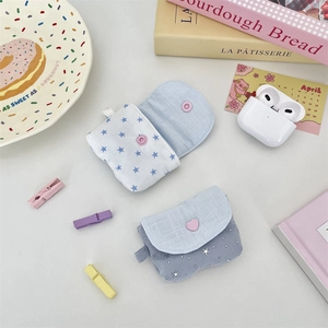 Detail of blue fabric star pattern earphone pouch with snap closure and heart button
