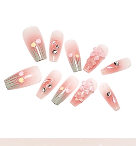 Detailed view of 3D tulip floral design and glitter accents on pink press-on nails