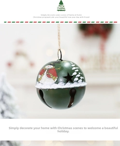 Close-up of green metal Christmas bell with snowman painting and star cutouts