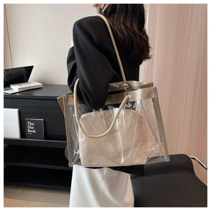 Detailed view of transparent PVC tote bag with beige canvas inner pouch and rope handles