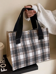 Women's plaid canvas tote bag with black strap and snap button closure for casual daily use