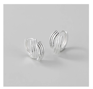 Detailed macro of S925 sterling silver hoop earrings with triple parallel line texture