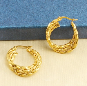 Detail view of the triple twisted rope texture on 18K gold plated hoop earrings